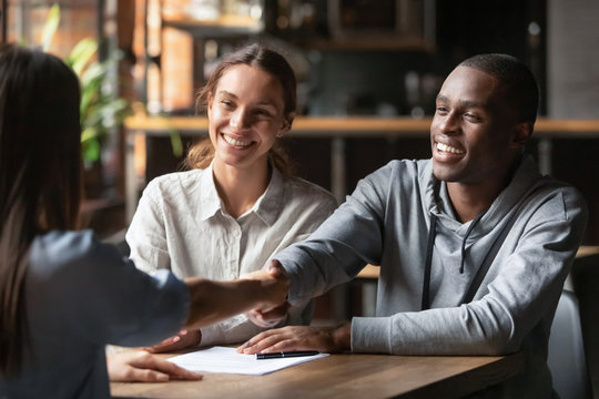Couple shaking hands with advisor after securing funding